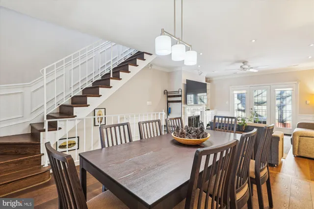 a view of a dining room and livingroom with furniture wooden floor and a chandelier