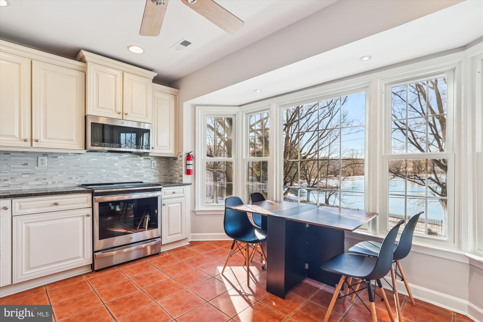 4611 1/2 MacArthur Boulevard Northwest, Unit B Washington, DC 20007 - Photo 12 of 43 a living room with furniture a flat screen tv and a fireplace