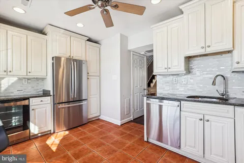 a kitchen with stainless steel appliances granite countertop a refrigerator and a sink