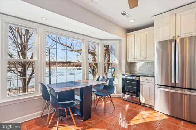a kitchen with stainless steel appliances granite countertop a refrigerator and a stove top oven