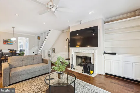 a living room with furniture a fireplace and a flat screen tv
