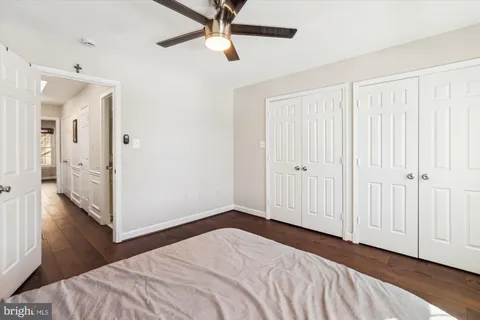 a view of a bedroom with wooden floor