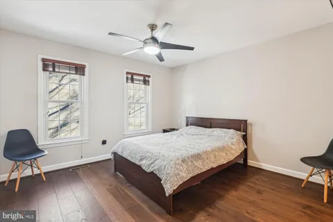 a bedroom with a bed and a chair in it