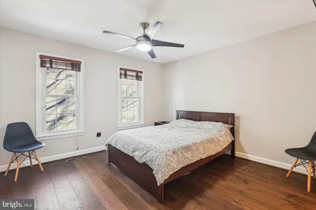 a bedroom with a bed and a chair in it