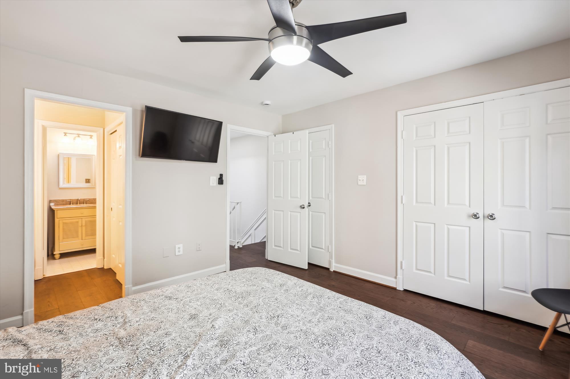 4611 1/2 MacArthur Boulevard Northwest, Unit B Washington, DC 20007 - Photo 33 of 43 a bedroom with a bed and a flat screen tv