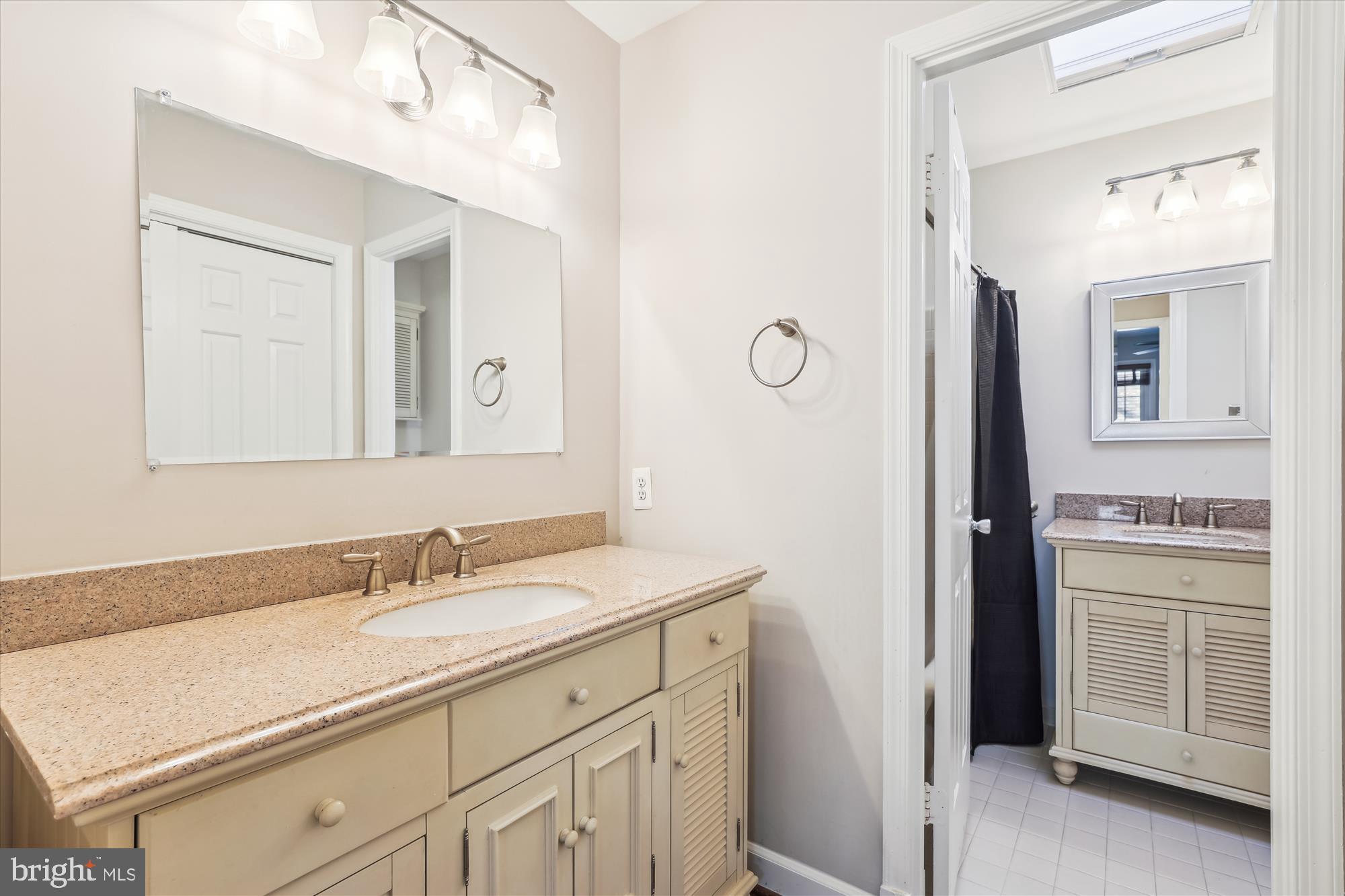 4611 1/2 MacArthur Boulevard Northwest, Unit B Washington, DC 20007 - Photo 34 of 43 a bathroom with a sink vanity granite and a mirror