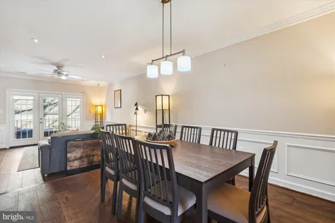a view of a a dining room with furniture window and wooden floor