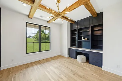 a view of an empty room with a window and closet