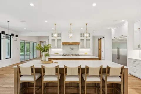 a view of a dining room with furniture and a large window