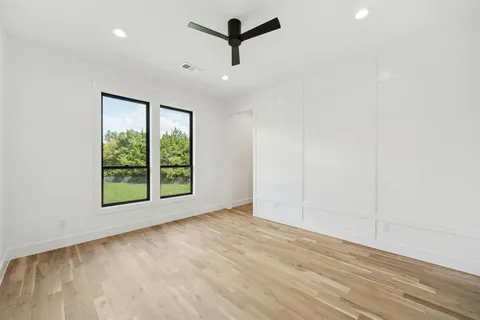 a view of a room with a window and a ceiling fan