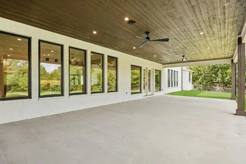 a view of an empty room with a sliding door and balcony