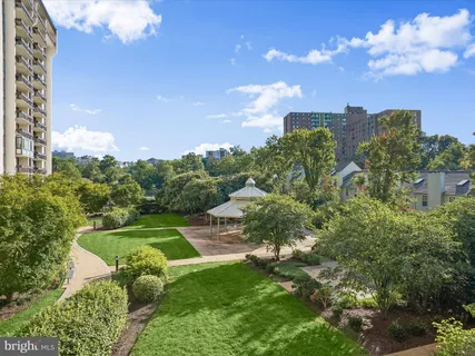 a view of a garden with a building in the background