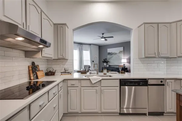 a kitchen with a sink a stove cabinets and counter space