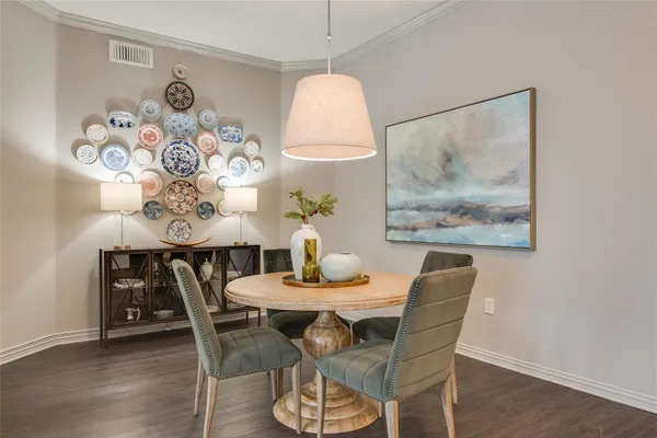 a dining room with furniture and wooden floor