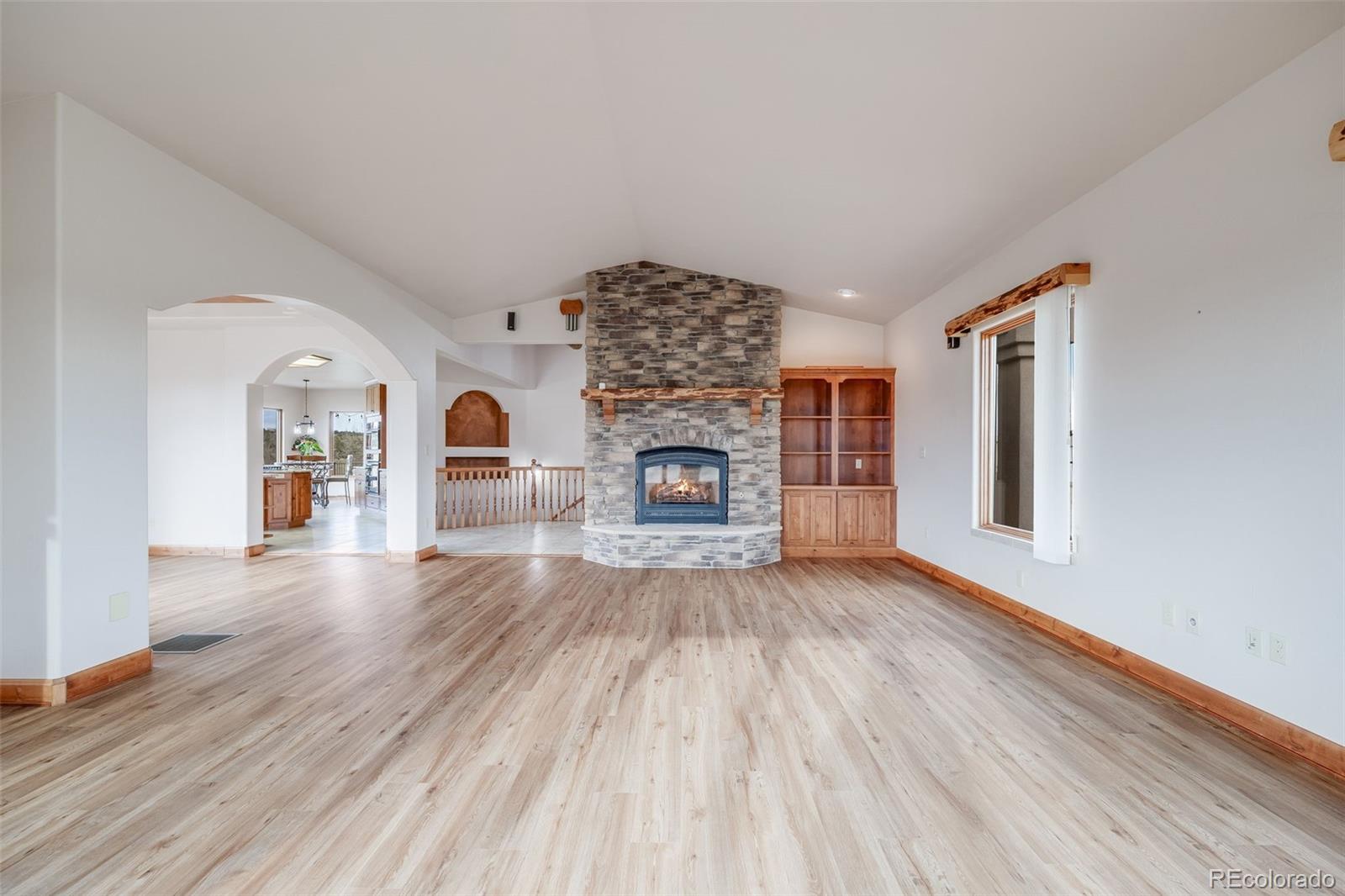 185 River Ridge Trail Walsenburg, CO 81089 - Photo 11 of 50 a view of livingroom with fireplace wooden floor and window