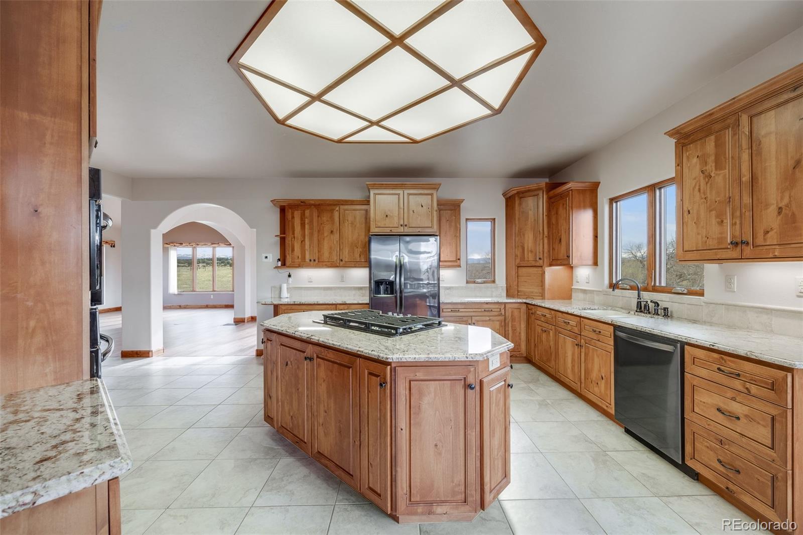 185 River Ridge Trail Walsenburg, CO 81089 - Photo 16 of 50 a kitchen with stainless steel appliances granite countertop a stove a sink dishwasher and a stove with wooden floor