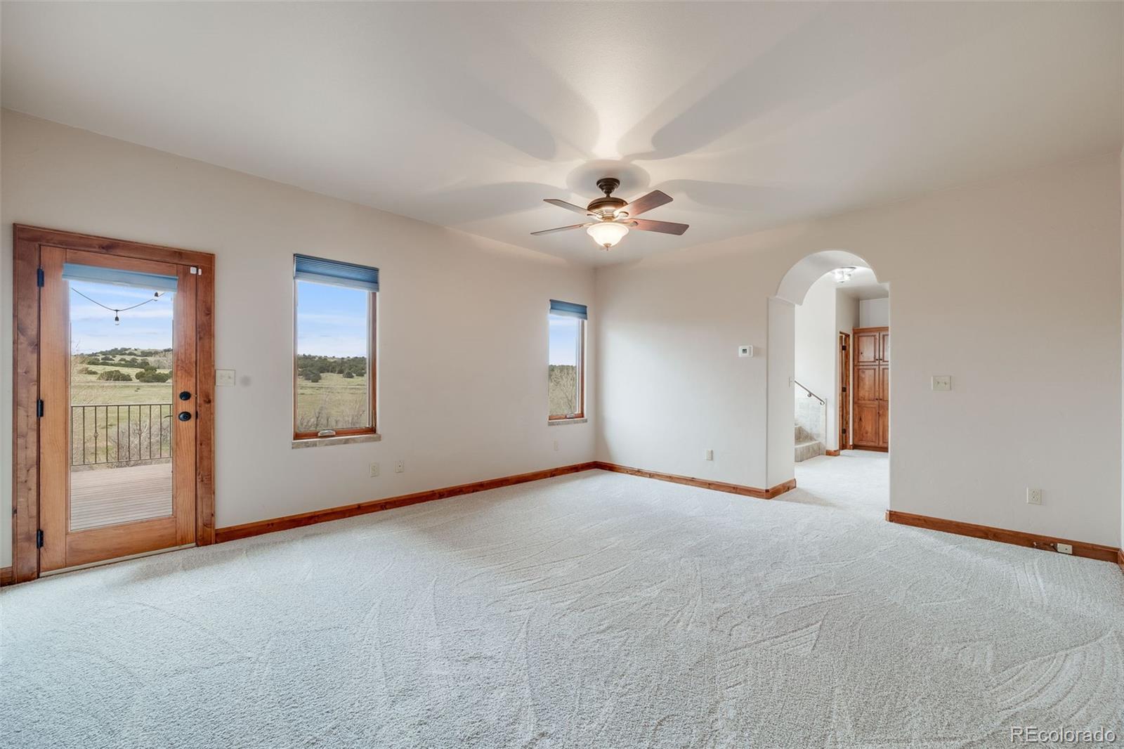 185 River Ridge Trail Walsenburg, CO 81089 - Photo 21 of 50 an empty room with chandelier fan and windows