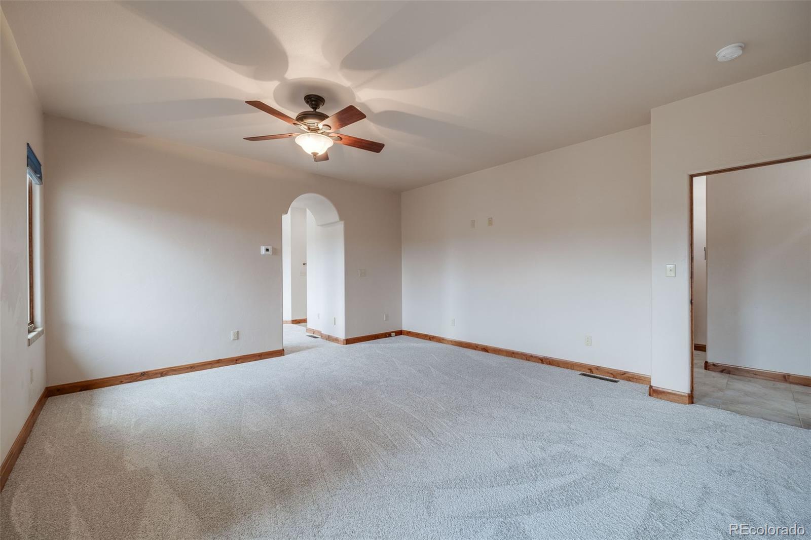 185 River Ridge Trail Walsenburg, CO 81089 - Photo 22 of 50 an empty room with a ceiling fan and a window