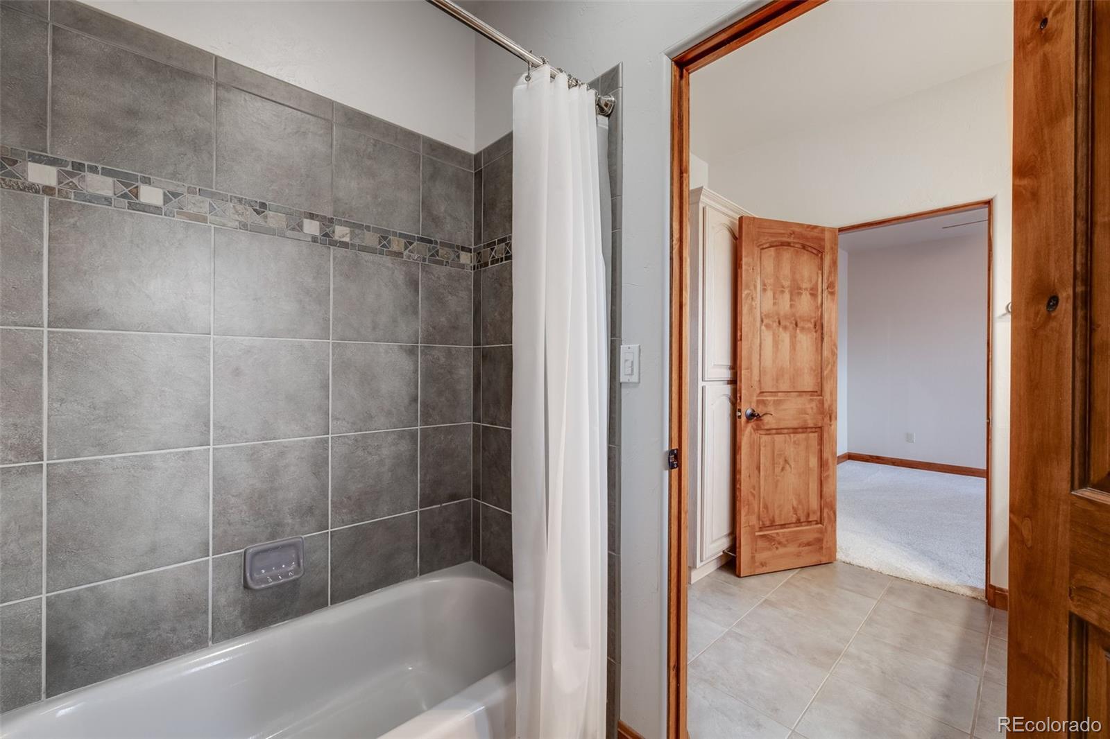 185 River Ridge Trail Walsenburg, CO 81089 - Photo 28 of 50 a bathroom with a bathtub and a shower
