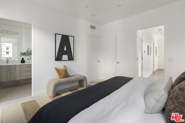 a bedroom with a bed and a couch