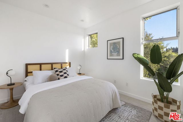 a bedroom with bed and a window