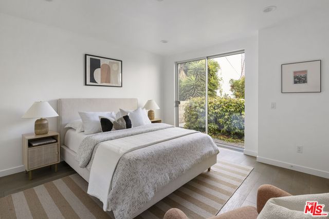 a large bed sitting in a bedroom next to a window