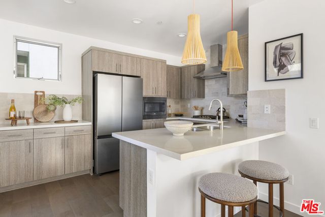 a kitchen with stainless steel appliances a sink and a refrigerator