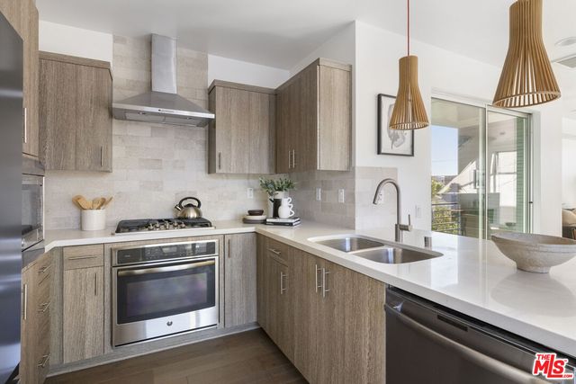 a kitchen with a sink stove and cabinets