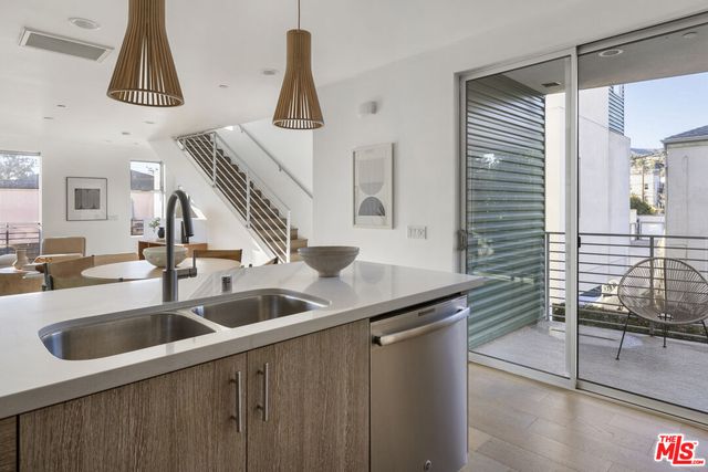a kitchen with a sink and mirror