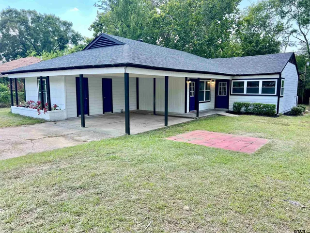 a front view of a house with a yard and porch