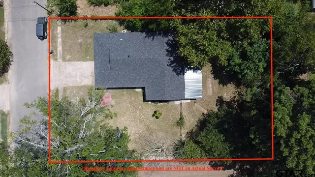 an aerial view of a house with a yard