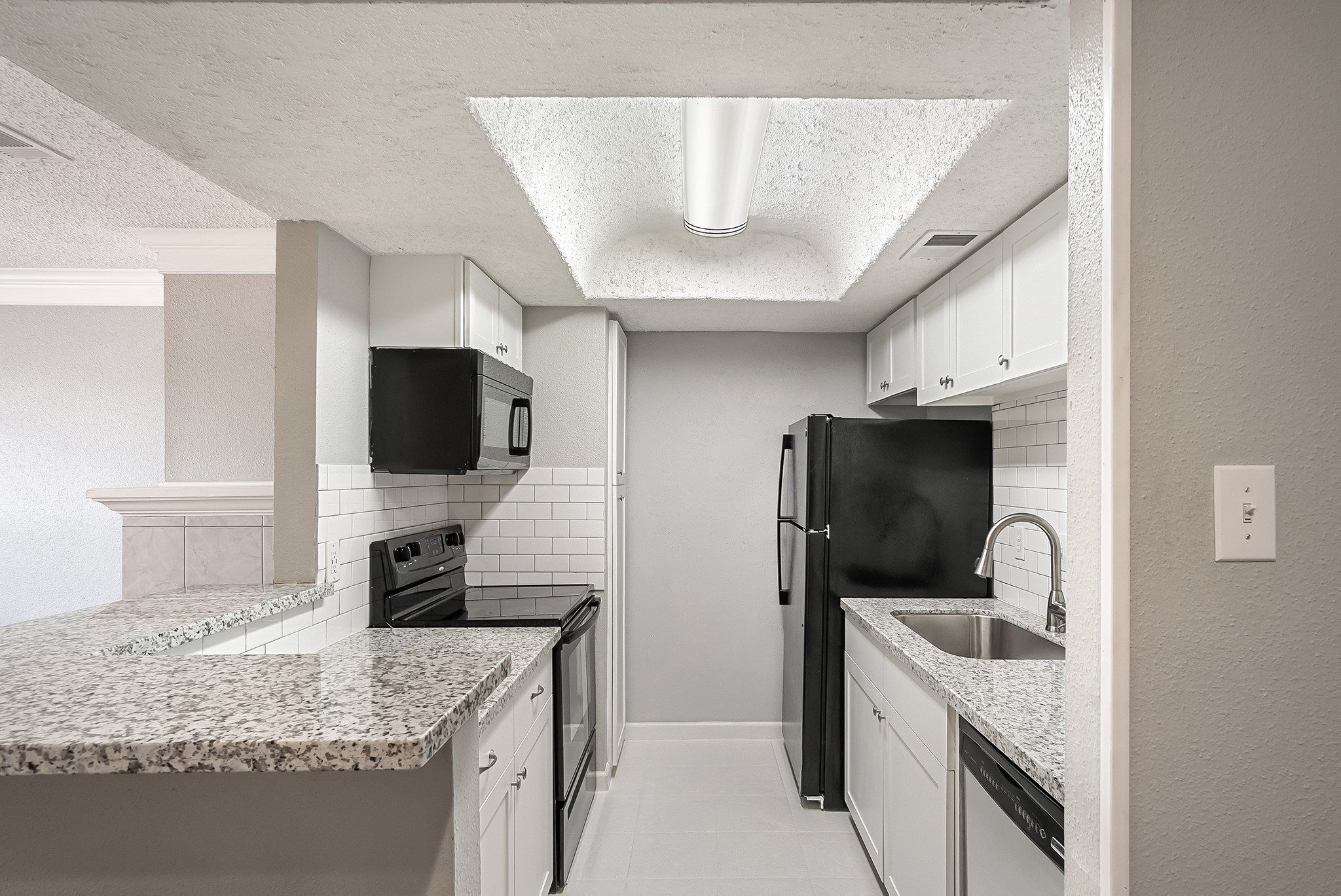 7402 Alabonson Road, Unit 510 Houston, TX 77088 - Photo 7 of 14 a kitchen with a sink stove and refrigerator