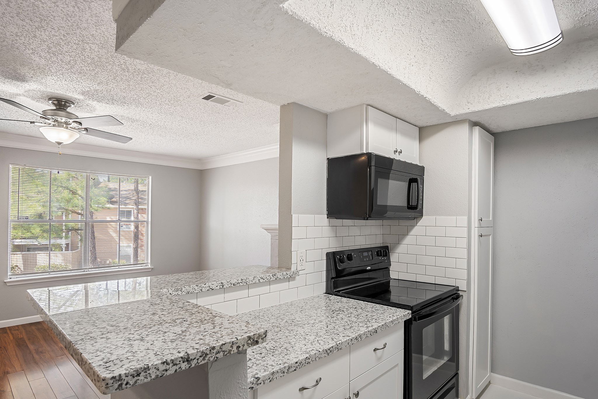 7402 Alabonson Road, Unit 510 Houston, TX 77088 - Photo 9 of 14 a kitchen with granite countertop sink and stove