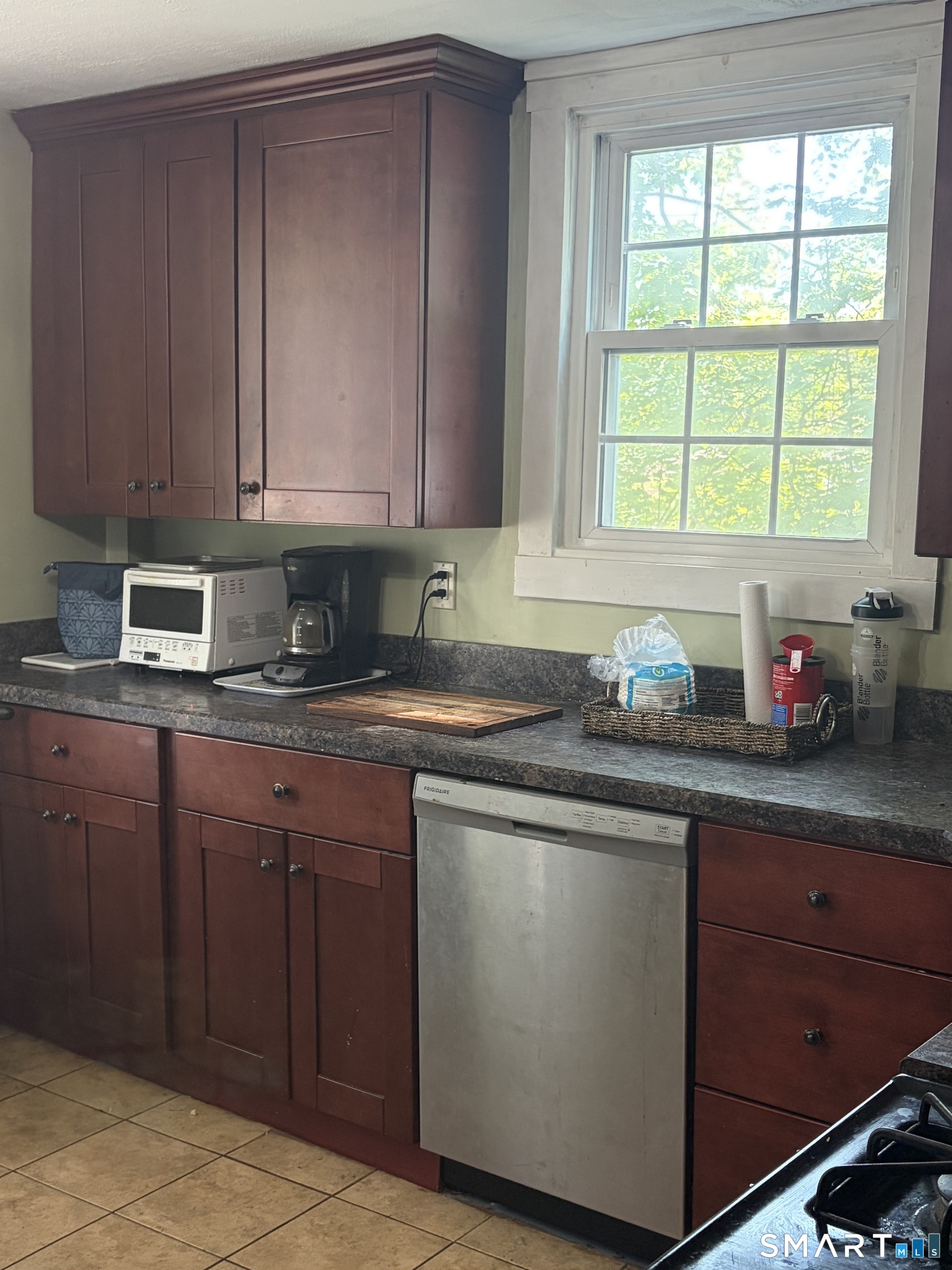 1079 Main Street Coventry, CT 06238 - Photo 6 of 19 a kitchen with granite countertop wooden cabinets a sink and dishwasher