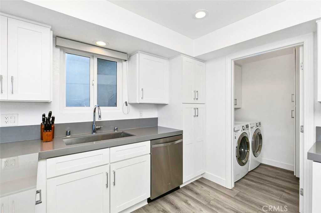 121 Boca De La Playa, Unit 1 San Clemente, CA 92672 - Photo 13 of 47 a kitchen with a sink and a washer dryer