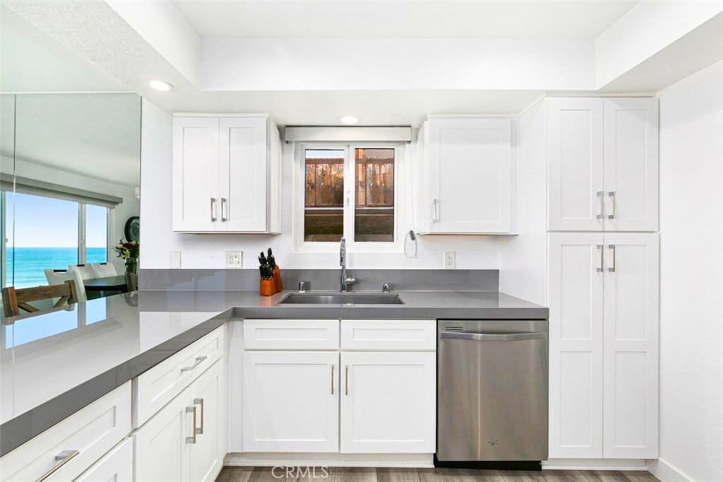 121 Boca De La Playa, Unit 1 San Clemente, CA 92672 - Photo 14 of 47 a kitchen with stainless steel appliances granite countertop a sink stove and cabinets
