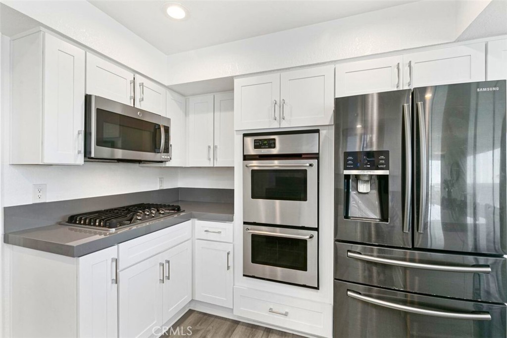 121 Boca De La Playa, Unit 1 San Clemente, CA 92672 - Photo 15 of 47 a kitchen with stainless steel appliances white cabinets a sink and a stove
