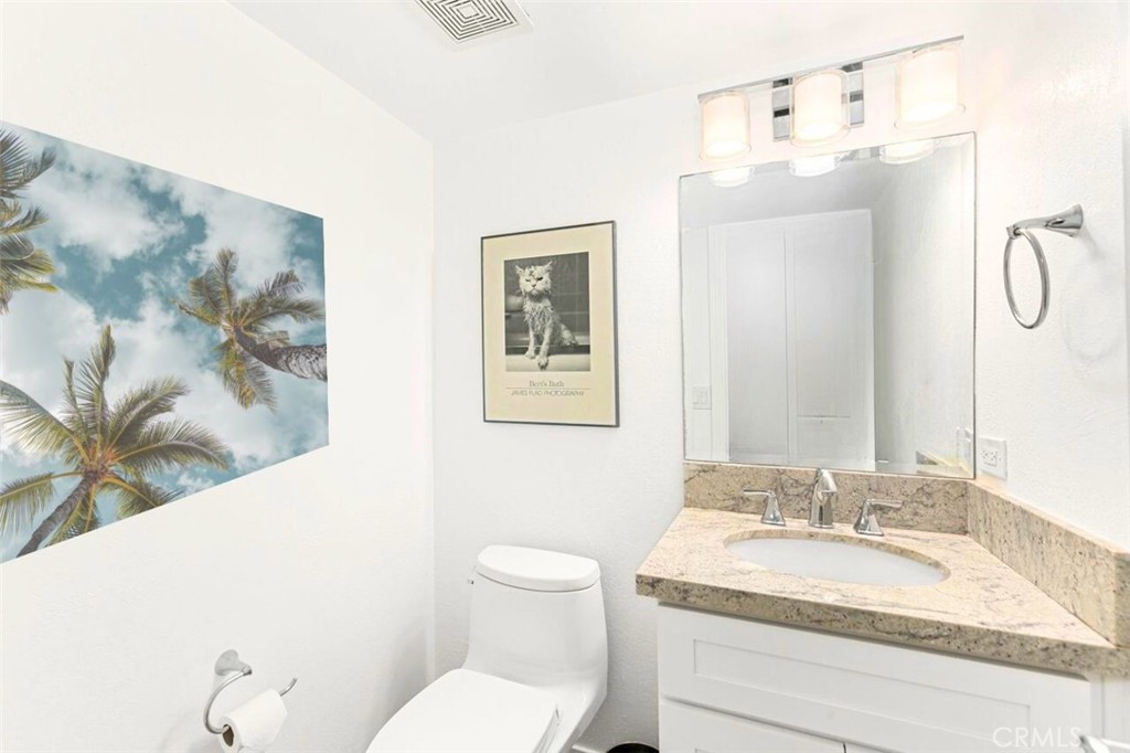 121 Boca De La Playa, Unit 1 San Clemente, CA 92672 - Photo 17 of 47 a bathroom with a granite countertop sink mirror vanity and toilet