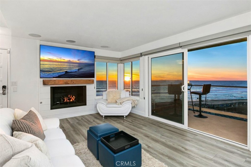 121 Boca De La Playa, Unit 1 San Clemente, CA 92672 - Photo 19 of 47 a living room with furniture a fireplace and a flat screen tv