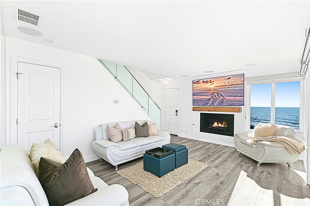 121 Boca De La Playa, Unit 1 San Clemente, CA 92672 - Photo 20 of 47 a living room with furniture a fireplace and a flat screen tv
