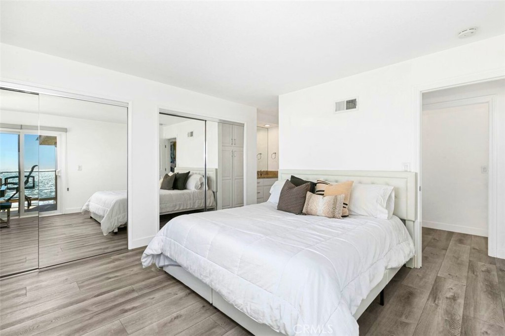 121 Boca De La Playa, Unit 1 San Clemente, CA 92672 - Photo 21 of 47 a bedroom with double bed and a couch