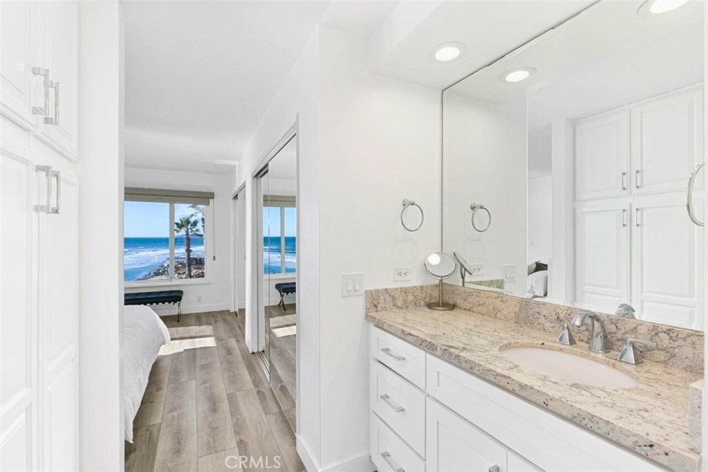 121 Boca De La Playa, Unit 1 San Clemente, CA 92672 - Photo 25 of 47 a bathroom with a granite countertop sink mirror and double