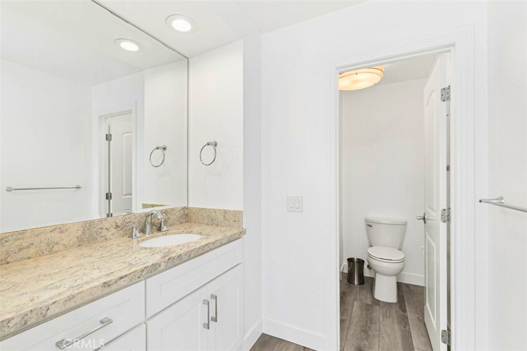 121 Boca De La Playa, Unit 1 San Clemente, CA 92672 - Photo 26 of 47 a bathroom with a granite countertop sink a toilet and a shower