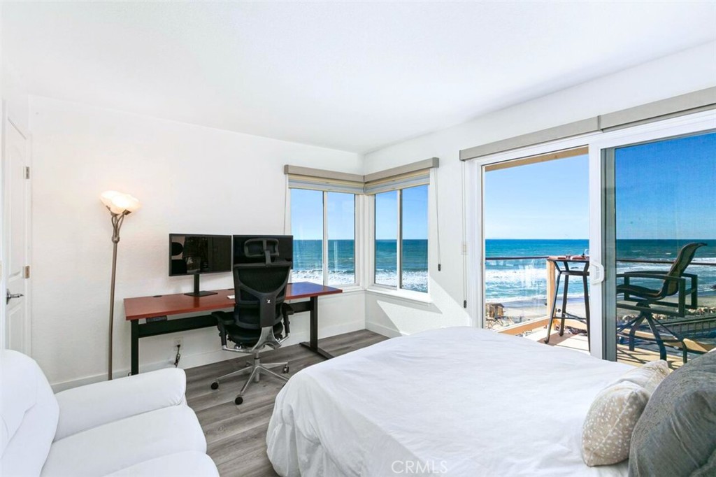 121 Boca De La Playa, Unit 1 San Clemente, CA 92672 - Photo 29 of 47 a bedroom with a bed and large windows