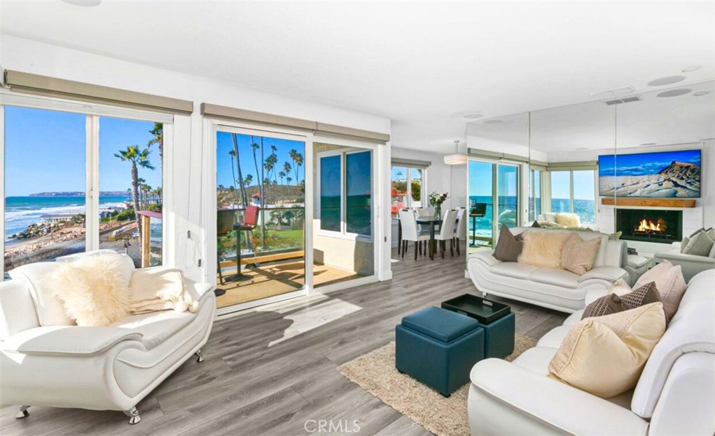 121 Boca De La Playa, Unit 1 San Clemente, CA 92672 - Photo 3 of 47 a living room with fireplace furniture and a large window