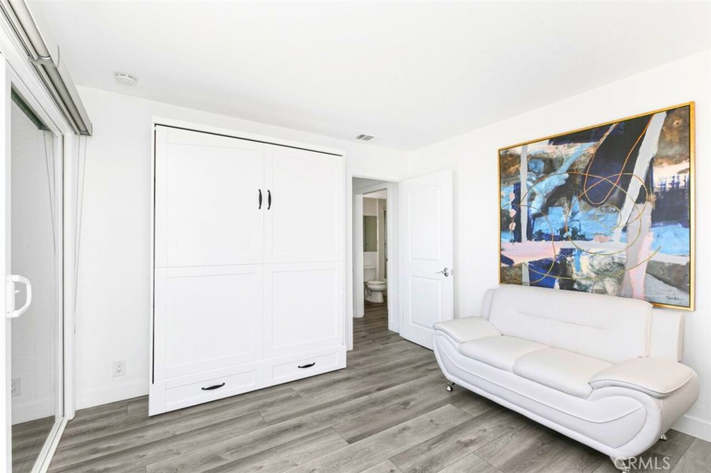 121 Boca De La Playa, Unit 1 San Clemente, CA 92672 - Photo 31 of 47 a living room with furniture and a refrigerator