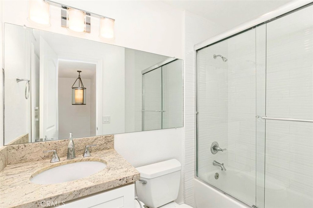 121 Boca De La Playa, Unit 1 San Clemente, CA 92672 - Photo 32 of 47 a bathroom with a granite countertop sink toilet and shower