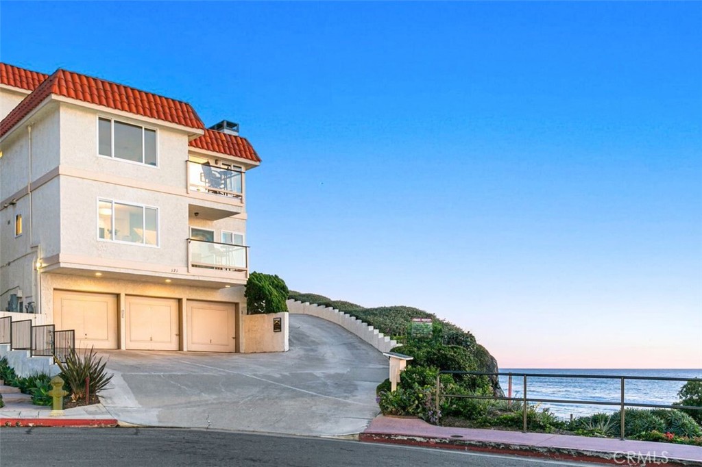 121 Boca De La Playa, Unit 1 San Clemente, CA 92672 - Photo 33 of 47 a front view of a house with a yard