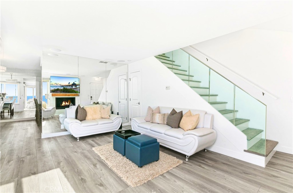 121 Boca De La Playa, Unit 1 San Clemente, CA 92672 - Photo 6 of 47 a living room with furniture and a wooden floor