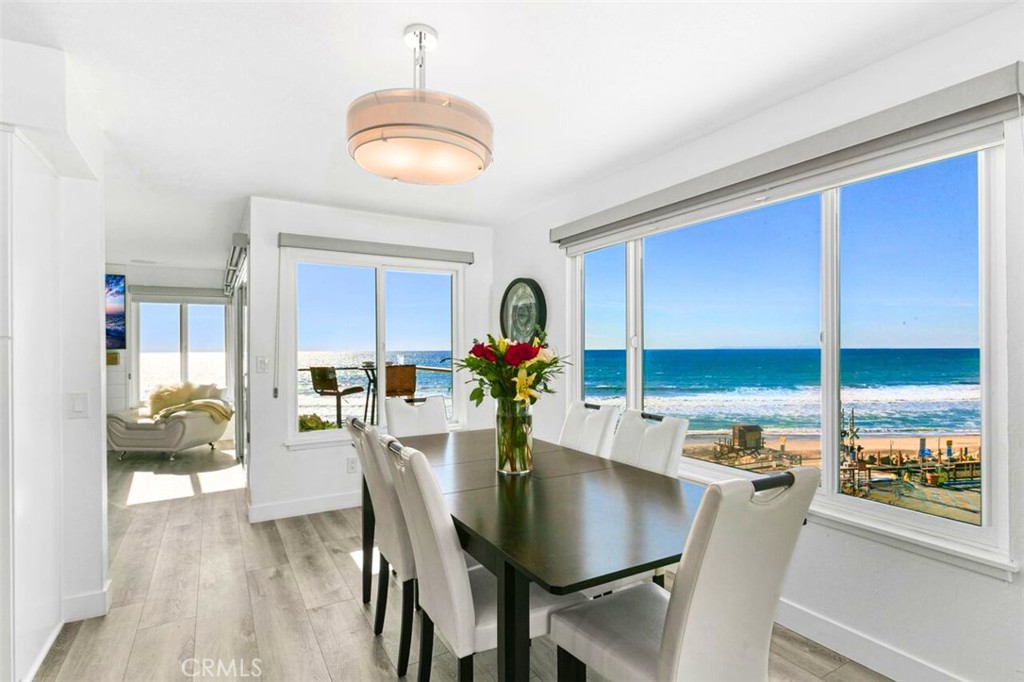 121 Boca De La Playa, Unit 1 San Clemente, CA 92672 - Photo 7 of 47 a dining room with furniture a chandelier and wooden floor